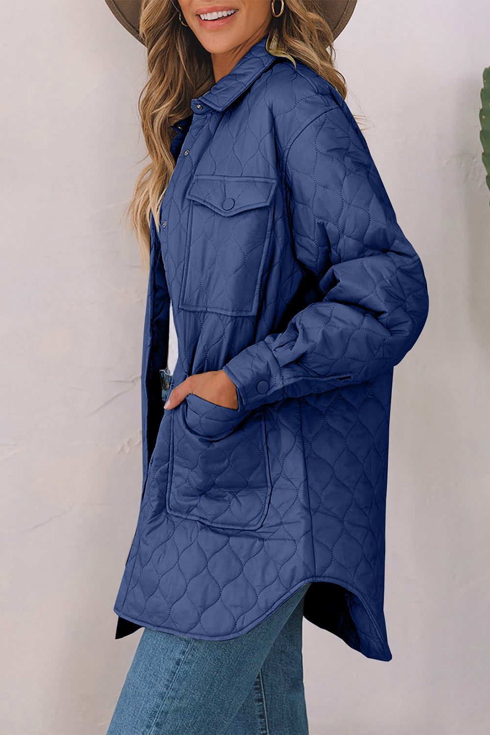French Blue quilted utility jacket with button-flap chest pockets and side pockets.
