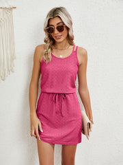 Hot pink eyelet crossover strap dress with drawstring waist and scoop neck.