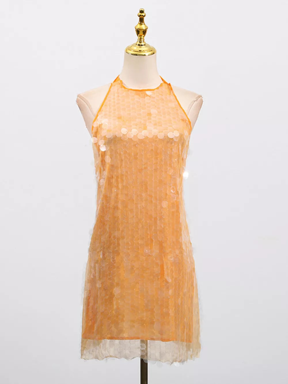 Orange iridescent sequin halter mini dress with a sheer hem.
