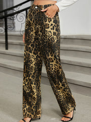 Leopard print wide-leg jeans with a buttoned closure and pockets.