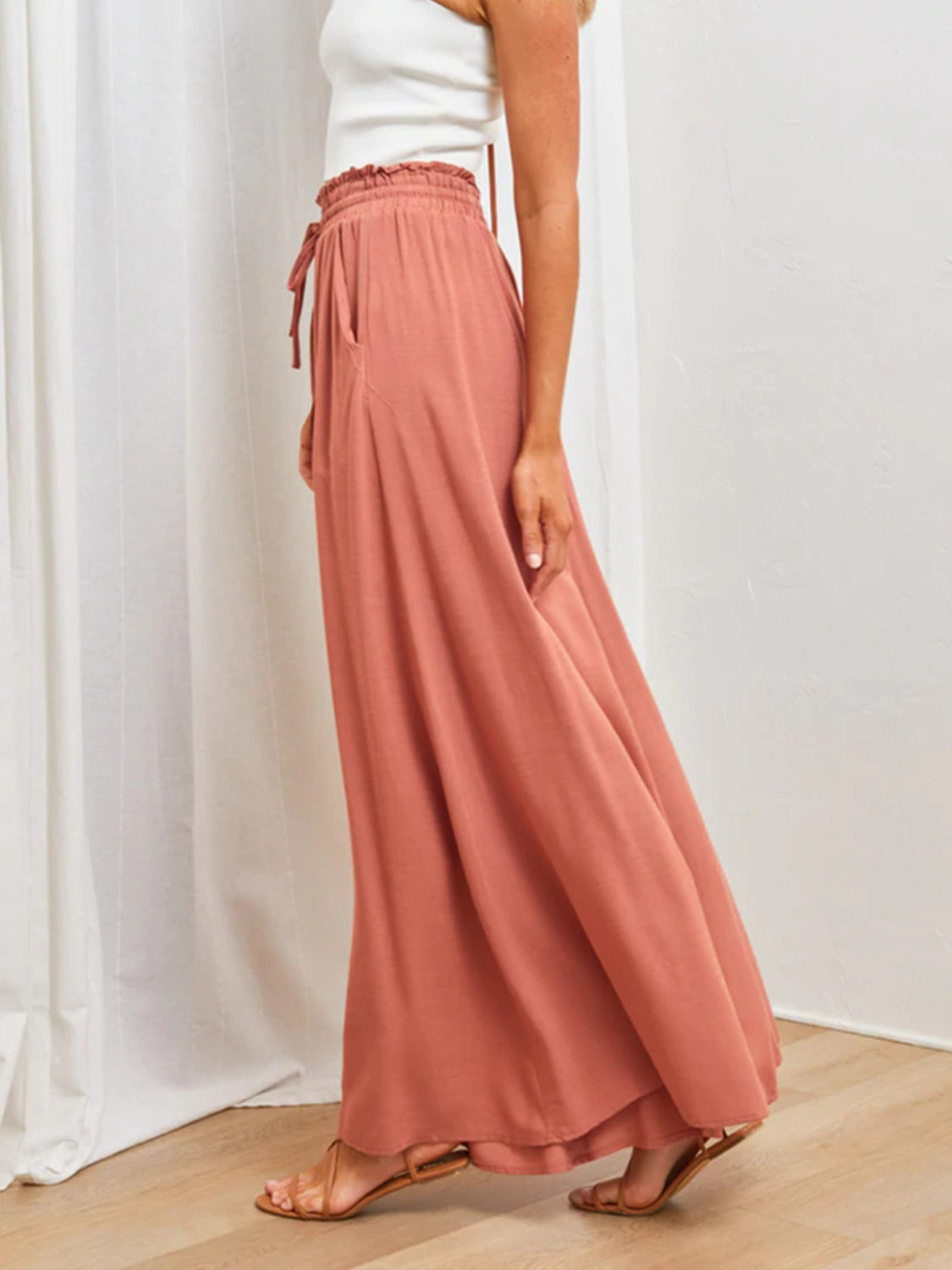Coral gathered waist wide-leg palazzo maternity pants with drawstring and pockets.
