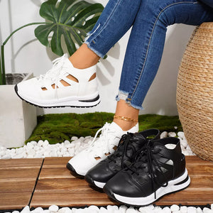 Chic white and black round toe lace-up sneakers with cut-out details.