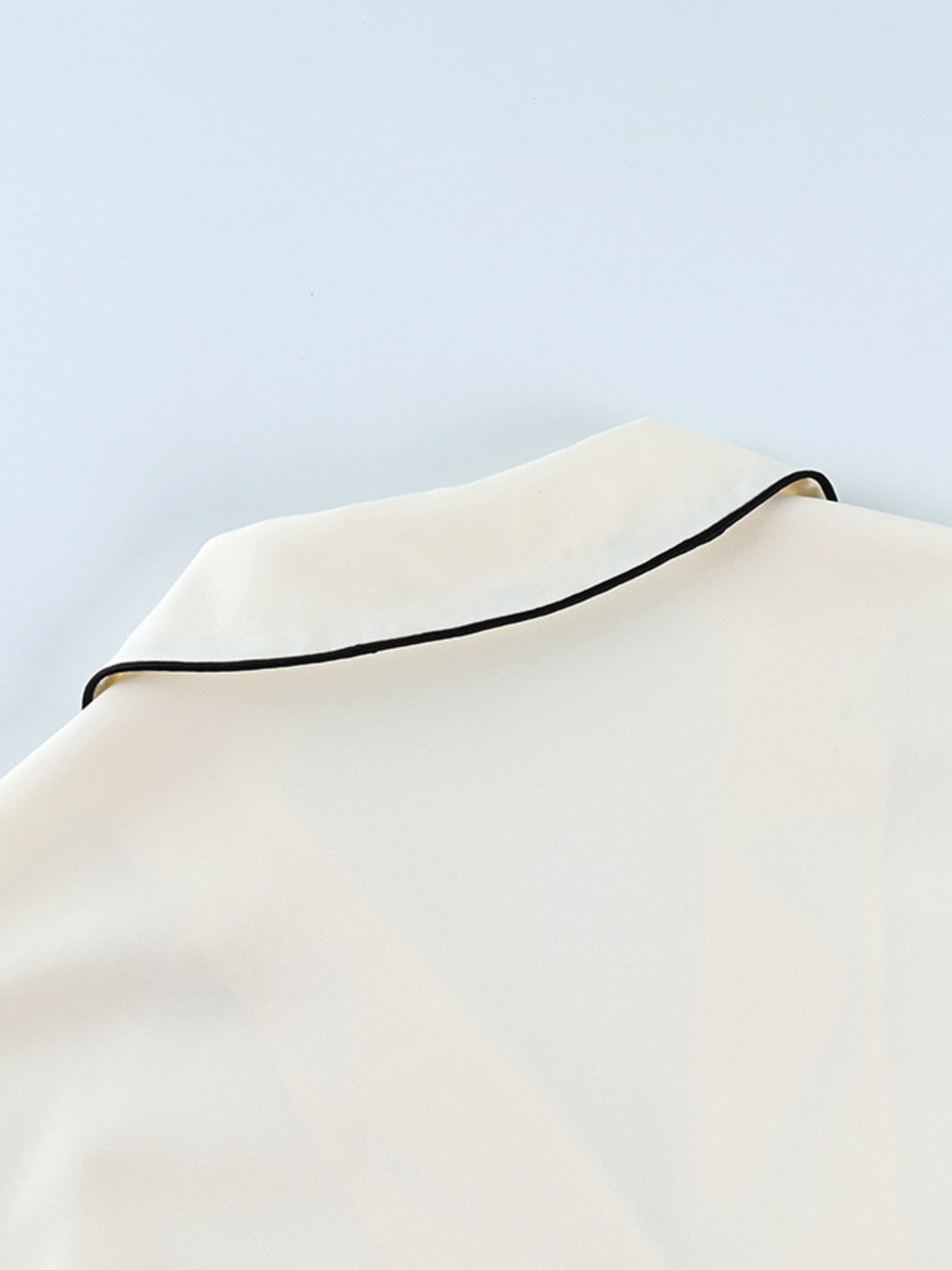 Cream button-up lounge set with black piping detail on collar