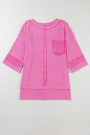 Fuchsia pink waffle knit top with raw seam details, crew neck, and chest pocket.