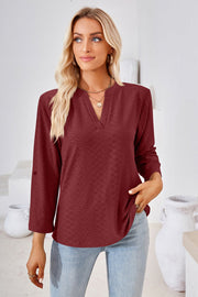 Burgundy textured henley blouse with rolled sleeves and a v-neck.
