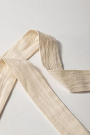 Beige cotton wrap skort with textured fabric and a tie detail.