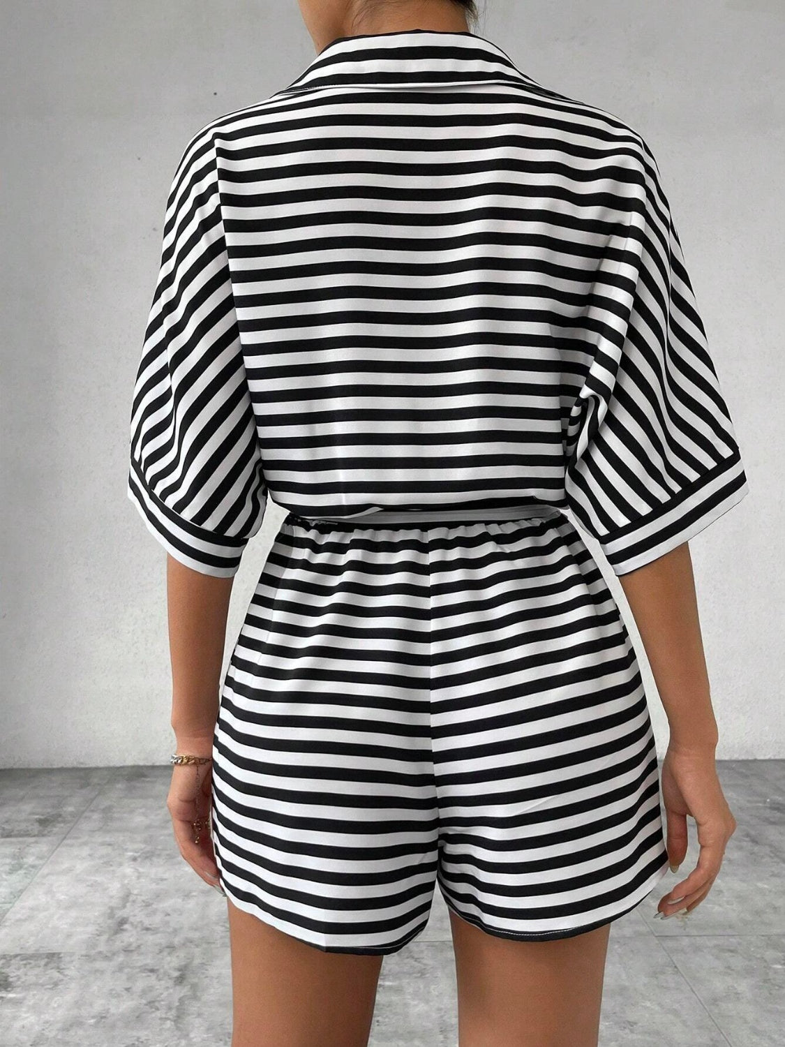 Black and white striped romper with self-tie belt and elastic waist shorts.