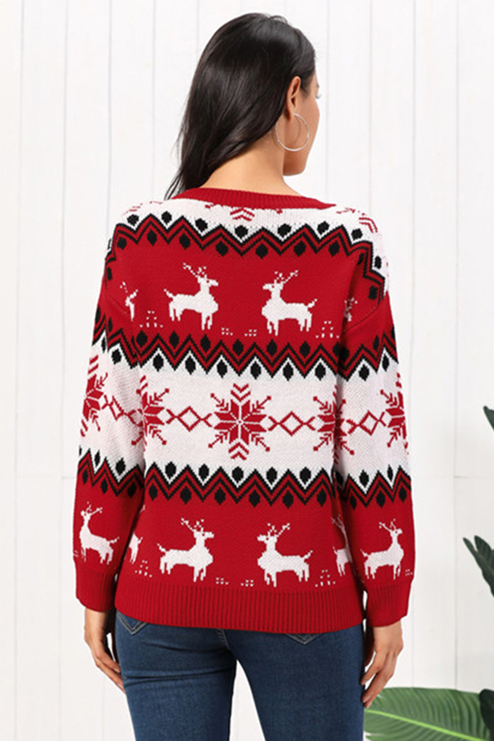 Red acrylic sweater with reindeer and snowflake Fair Isle pattern, crew neck, long sleeves.