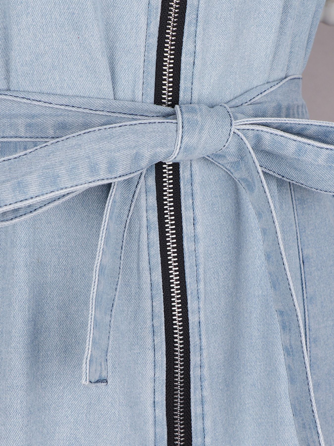 Light wash denim mini dress with zipper front and tie waist
