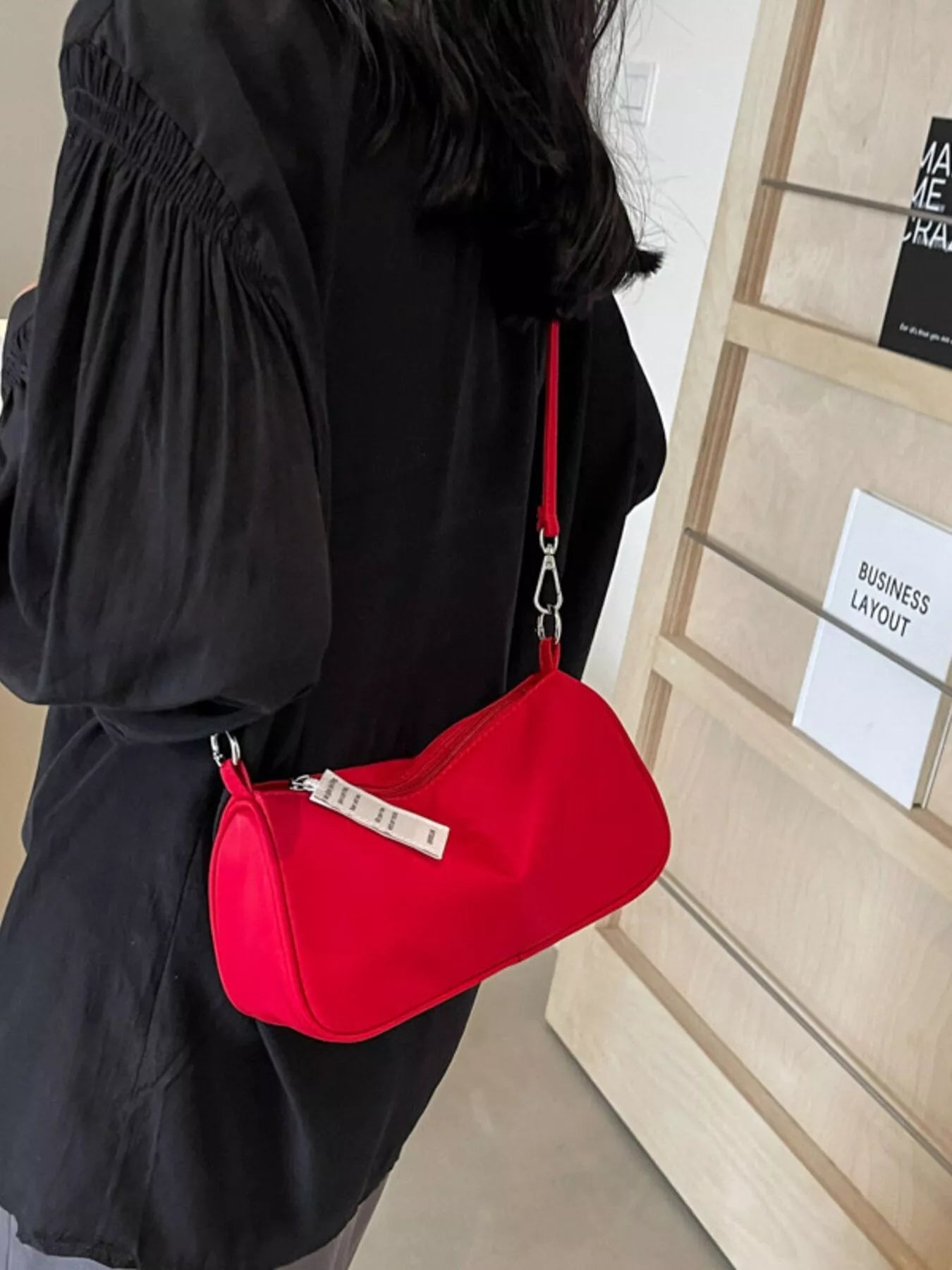 Red nylon mini crossbody bag with a compact design and zipper closure.