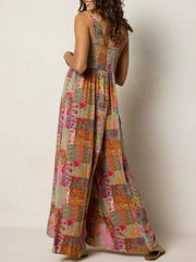 Vibrant patchwork wide-leg romper with smocked bodice and square neckline.