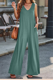 Flowing palazzo jumpsuit in Matcha Green with V-neck and wide legs.