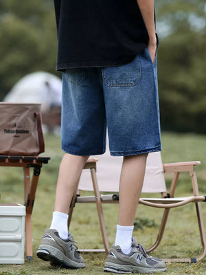 Relaxed fit blue denim shorts with drawstring and utility pockets.