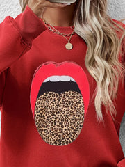 Red crewneck sweatshirt with bold leopard tongue graphic.