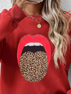 Red crewneck sweatshirt with bold leopard tongue graphic.