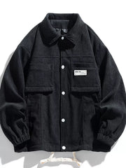 Black corduroy button-down jacket with two chest pockets and white buttons.