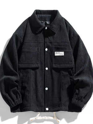 Black corduroy button-down jacket with two chest pockets and white buttons.