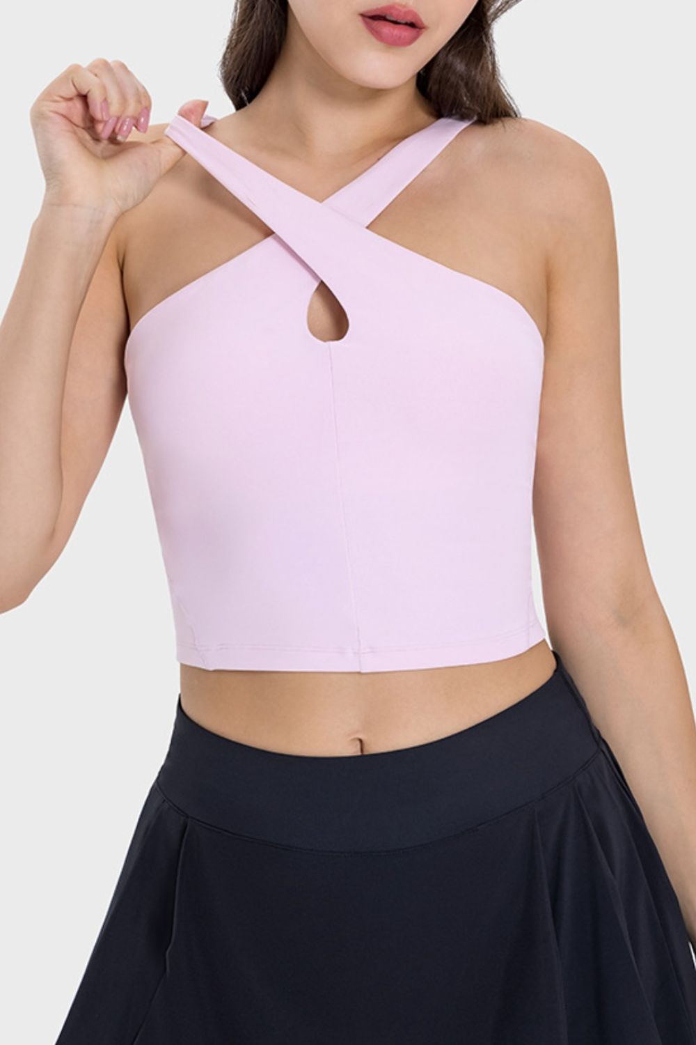 Blush pink keyhole halter crop top with crisscross straps.