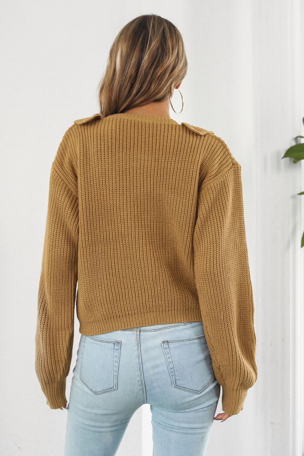 Camel acrylic knit cardigan with ruffled collar detail and ribbed texture.