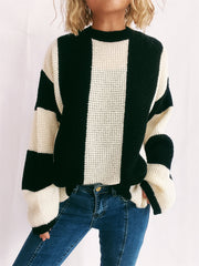 Black and cream vertical stripe waffle knit sweater with crew neck and long sleeves.