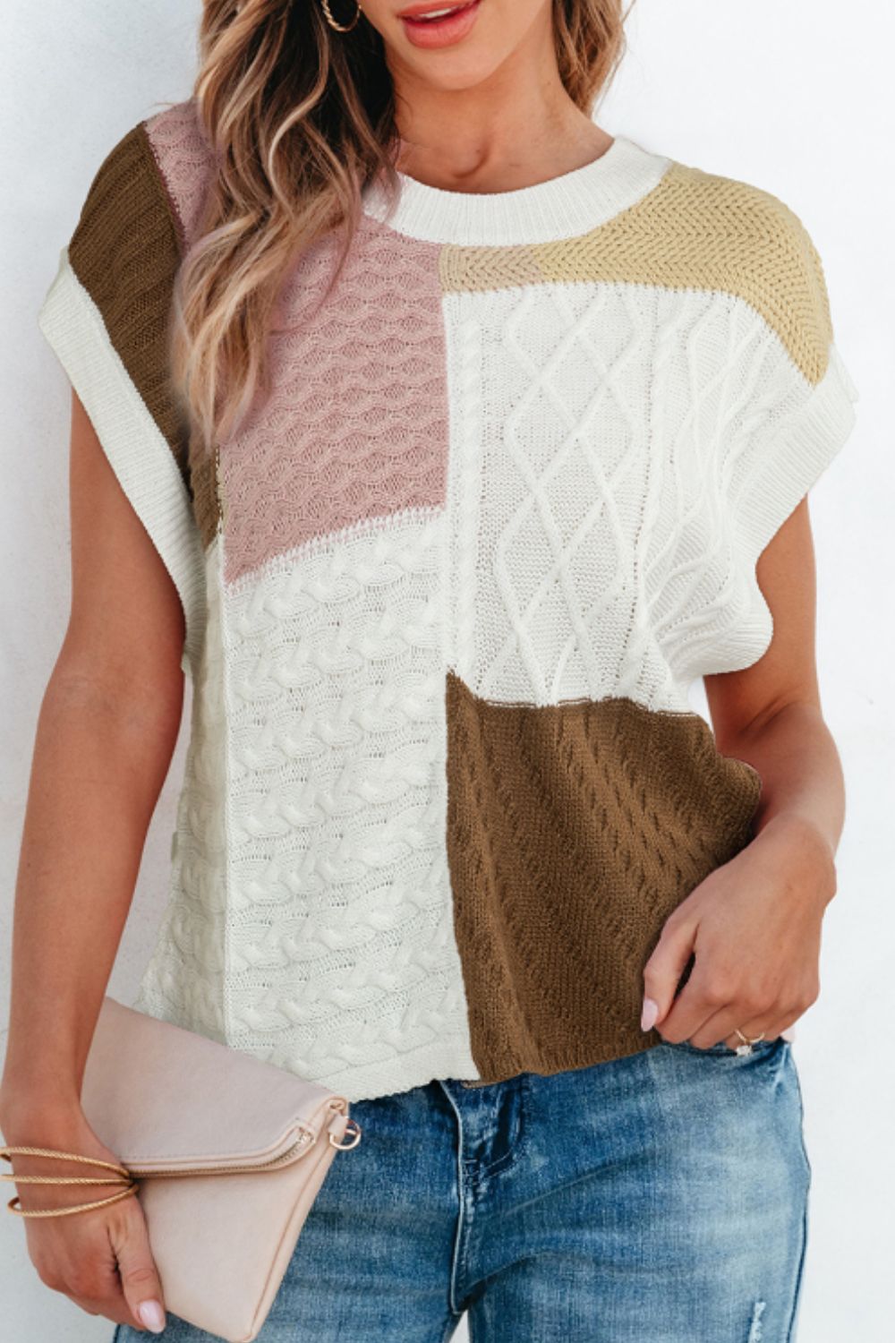 Patchwork cable knit tank top in dusty pink, white, brown, and cream with short sleeves.
