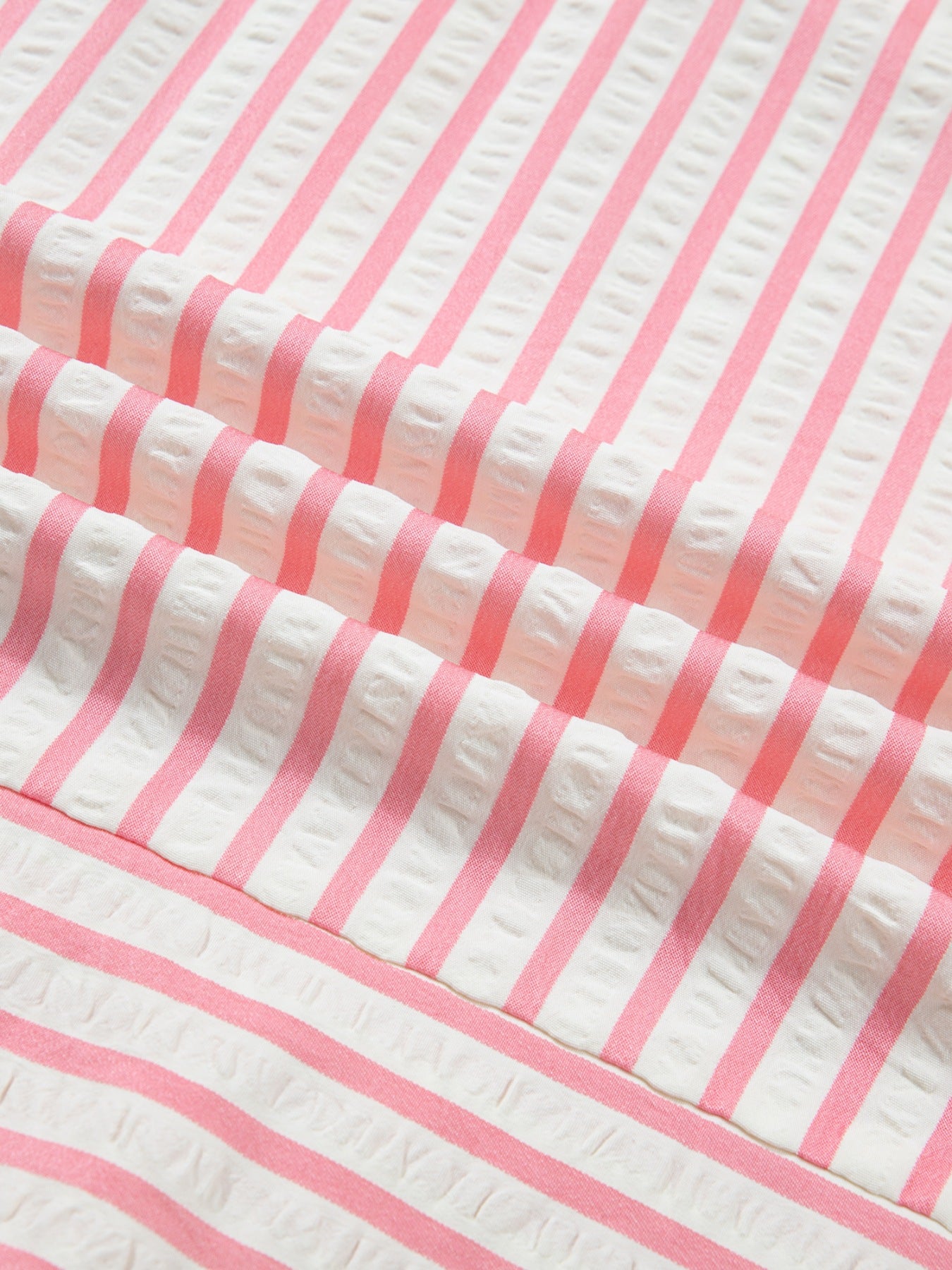 Pink and white striped textured blouse fabric detail