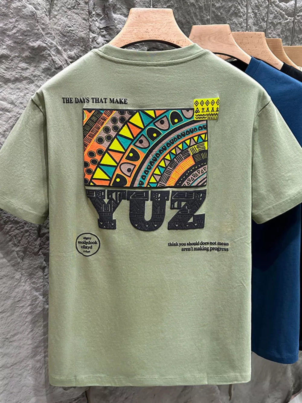 Men's Matcha Green Cotton Graphic T-shirt with abstract print and text.