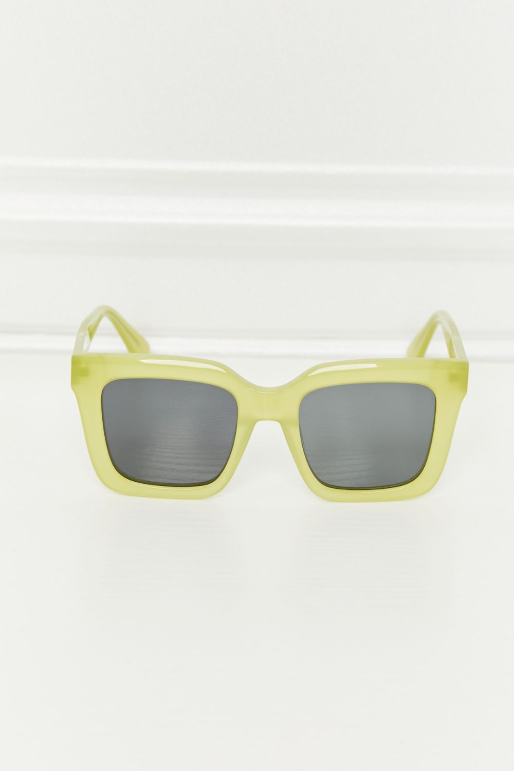 Citron box frame sunglasses with dark lenses and acetate frames.