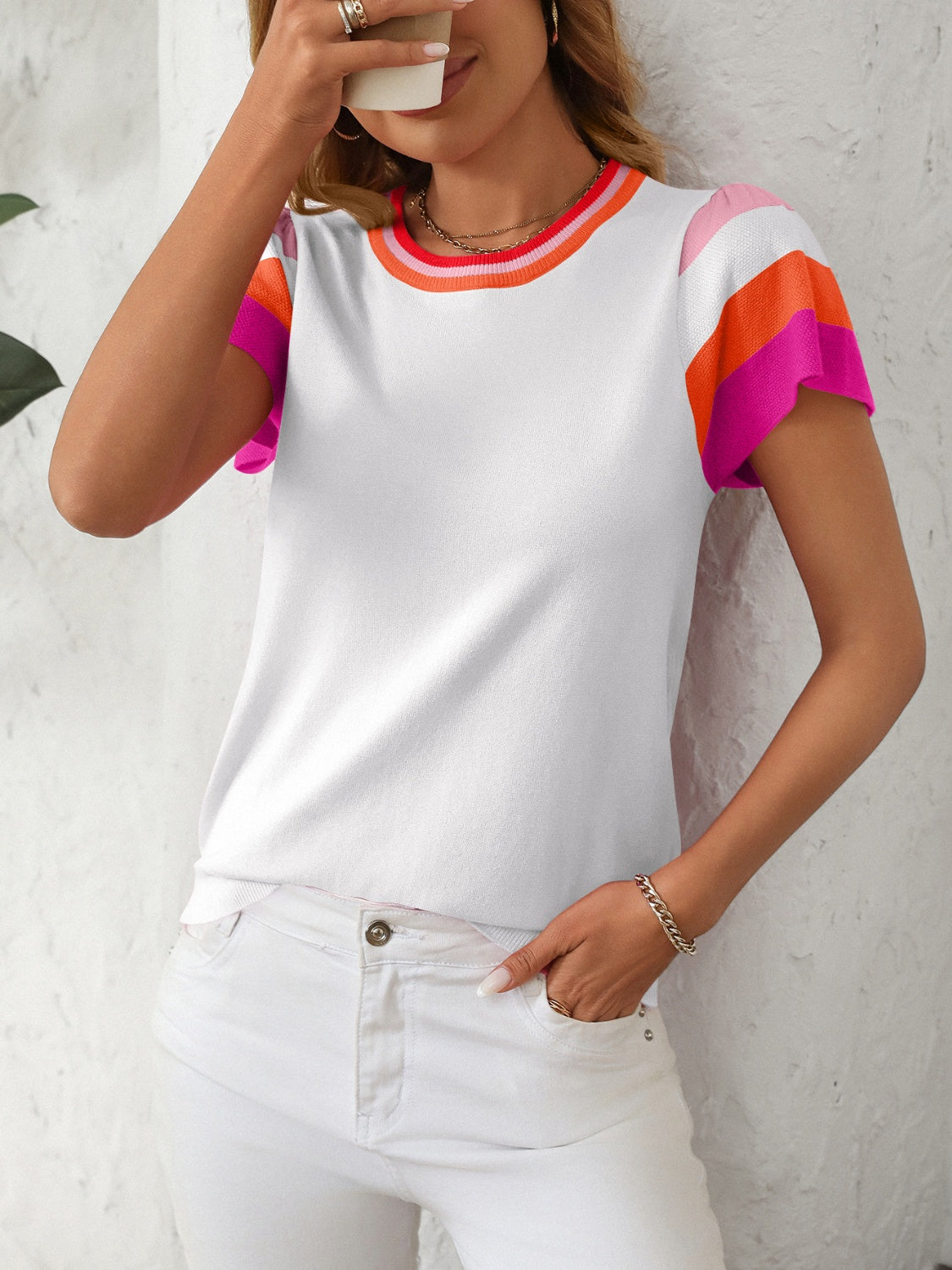 Colorblock knit top with flutter sleeves and striped neckline in white, hot pink, orange, and sky blue.