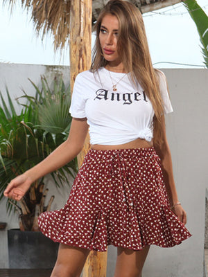 White Angel graphic tee with knot front detail, paired with a red floral print mini skirt.