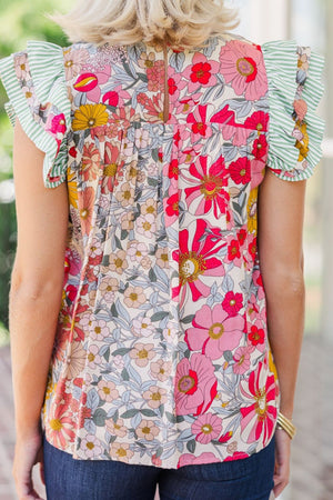 Floral blouse with ruffle sleeves and a mixed floral print.