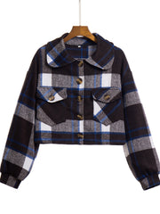 Chic plaid jacket in dark blue, white, and gray with buttoned chest pockets and a collared neckline.