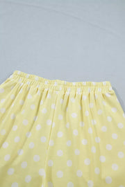 Pastel yellow polka dot polyester shorts with elastic waistband