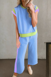 Light blue sportswear set with contrast trim on sleeves, neckline, waistband, and pants.