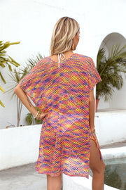 Open-knit beach caftan with slit hem in multicolor yarn, short sleeves, and a relaxed fit.
