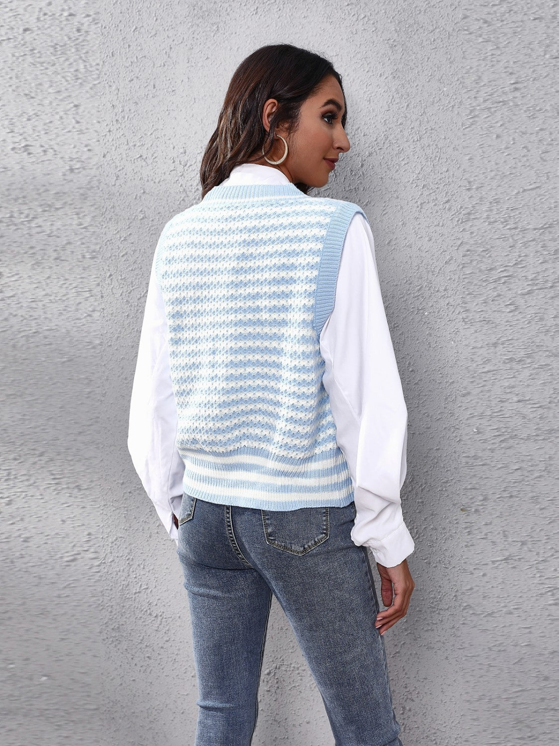 Light blue and white striped knit vest with a V-neck and ribbed trim.