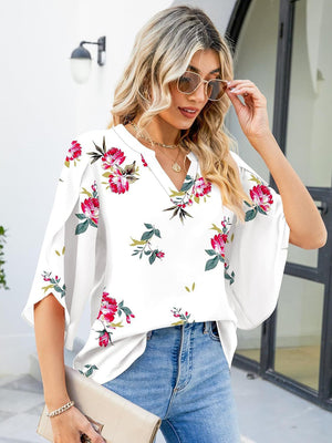 White floral blouse with flutter sleeves and V-neck