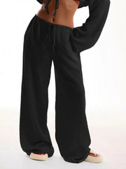 Black maternity pants with wide legs and drawstring waist.