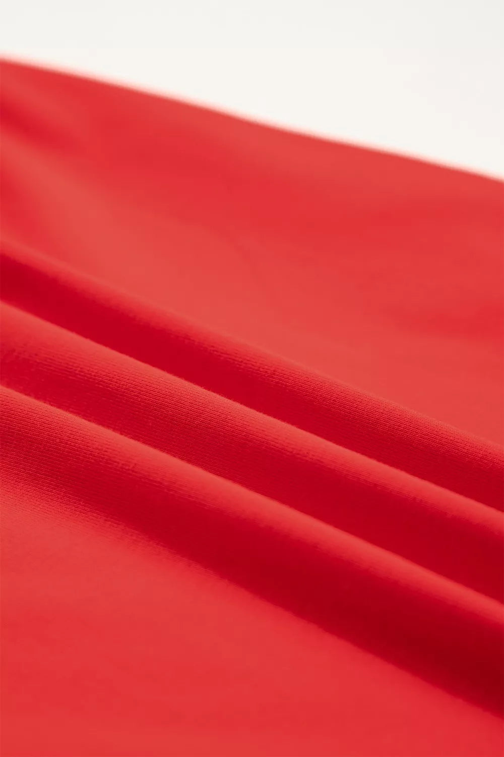 Red cotton mini dress with a textured fabric detail.