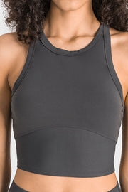 Gray sculpted neckline crop top with racerback straps and a curved hem detail.