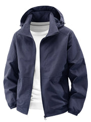 Dark blue hooded windbreaker jacket with zipper and pockets, worn over a white t-shirt.