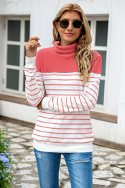 Colorblock stripe turtleneck knit sweater with coral and white horizontal stripes.