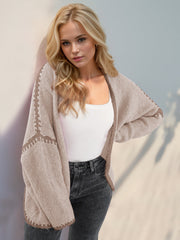 Oversized knit cardigan in tan with contrast stitching detail on sleeves and hem.