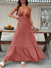 Plunging V-neck tiered maxi dress in rust with adjustable spaghetti straps and a gold buckle detail.
