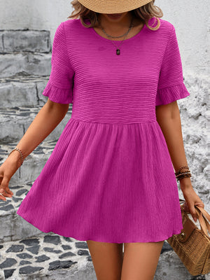 Textured babydoll blouse in deep rose with flutter sleeves and a cinched waist.