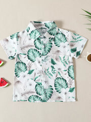 Baby cotton shirt with tropical leaf print, short sleeves, button front, and chest pocket.