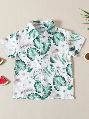 Baby cotton shirt with tropical leaf print, short sleeves, button front, and chest pocket.