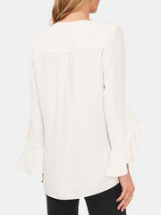 White chiffon blouse with V-neck and flared sleeves.