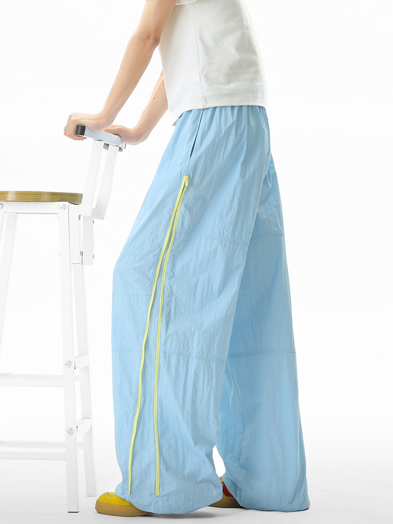 Men's pastel blue loose-fit casual sweatpants with yellow drawstring detail.
