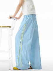 Men's pastel blue loose-fit casual sweatpants with yellow drawstring detail.